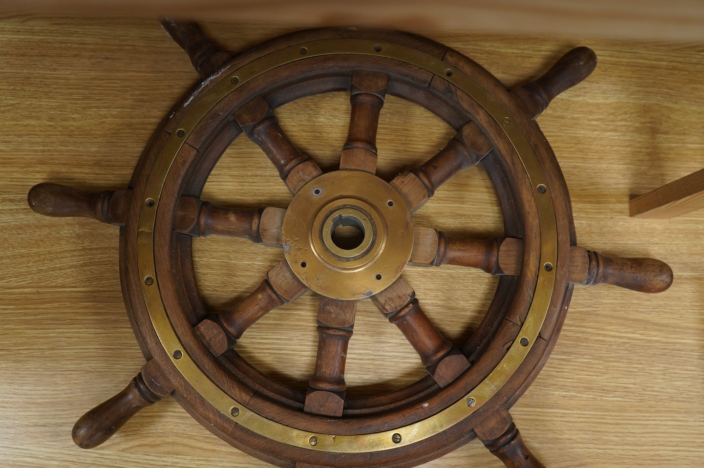 Maritime interest, a brass mounted hardwood ship’s wheel, 68cm in diameter. Condition - fair